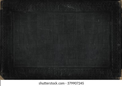 Black vintage background from distress fabric texture with antique ornamental frame, framework for your content.