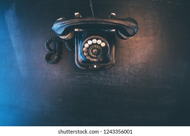 Black Vintage Landline Telephone, Old And Weathered. Broken Communication Concept.