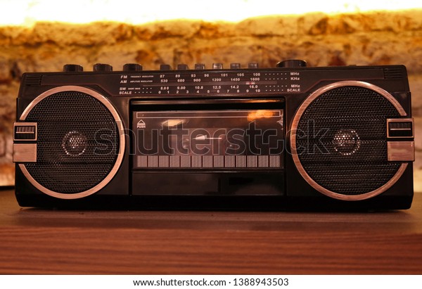 A black\
vintage radio tape on a wooden\
shelf