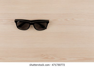 Black Vintage Sun Glasses On Wood, Top View