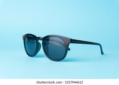 Black Vintage Sunglasses On A Clear Blue Background.