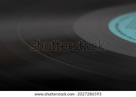 Black vinyl record. Selective focus. The music tracks are visible.
