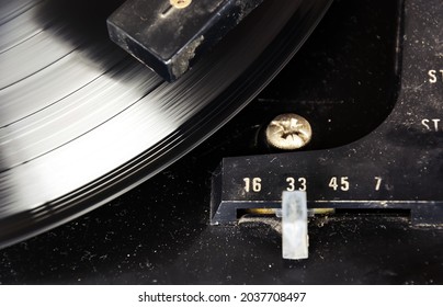 black vinyl record spinning on the turntable with the speed selector set to 33 rpm. Vintage audio equipment. Vinyl record player - Shutterstock ID 2037708497