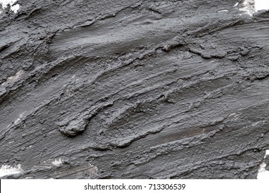 Black Volcanic Cosmetic Clay Texture Close Up. Solution Of Cosmetic Clay Abstract Background.