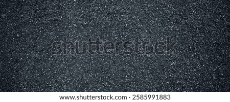 Black volcanic stone. Surface of basalt or granite close-up. Dark rough and textured rock. Dark toned background .
