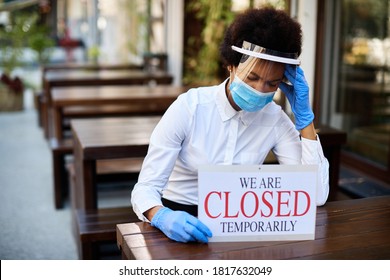 Black Waitress Holding Closed Sign And Feeling Worried About Going Out Of Business Due To Coronavirus Pandemic. 