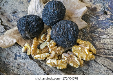 Black Walnuts In Still Life On Log