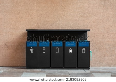 Black wastebaskets for separation of garbage on the street of Istanbul.