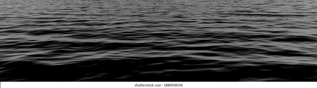 black water sea wave. black water banner and surface of dark nature background. Black water texture. ripple effect on surface sea water in black and white color. cover page.