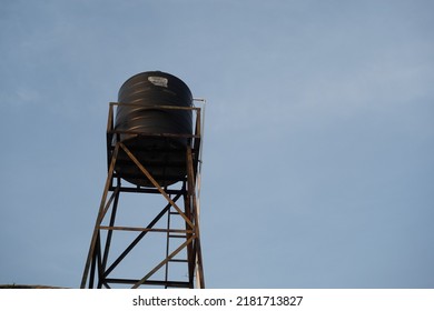 A Black Water Tank That Is Installed On The Roof Of The House