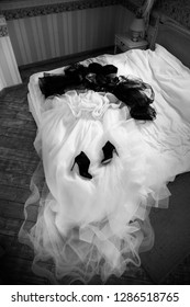 Black Wedding Shoes And Wedding Dress On The Bad