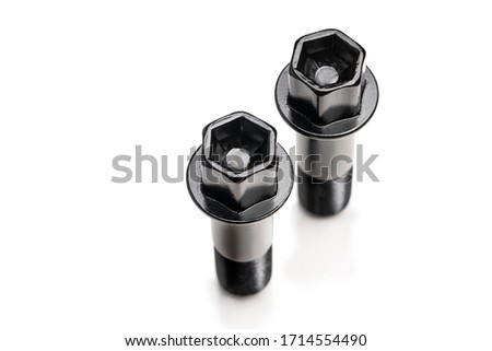 black wheel bolts on a white background, isolate. auto parts top view