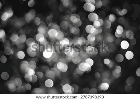 A black and white abstract background featuring numerous out-of-focus bokeh lights, creating a dreamy and festive atmosphere.