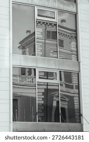 Black and White Architectural Reflection of Classical Building in Modern Glass Office Facade