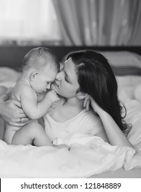 Black And White Art Photo Of Beautiful Mother Embrace Baby Boy,  Focus On Mother