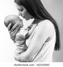 Black And White Art Photo Of Beautiful Mother Holding Baby Boy