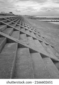 Black And White Atmospheric Portrait Shot Of Concrete Coastal Flood Defences