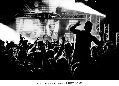 Black and White Audience Crowd Man on Shoulders Silhouette Dancing to DJ Pete Tong at Cream Nightclub Party. Nightlife Lazer Show Hands In Air With Smoke Cannon Blast