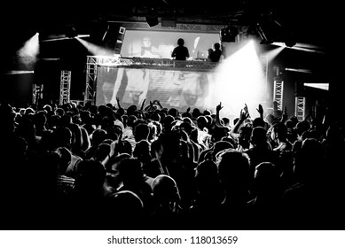 Black and White Audience Crowd Silhouette Dancing to DJ Pete Tong at Cream Nightclub Party. Nightlife Lazer Show Hands In Air With Smoke Cannon Blast