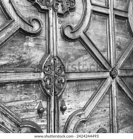 Black and white background of a closeup view of a 17th century church door