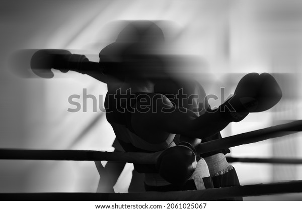 Black and white background\
image on the theme of boxing.  Combat sports. Silhouettes without\
faces.
