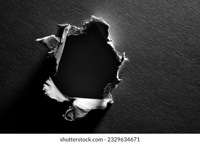 Black and white background of torn paper with hole - Shutterstock ID 2329634671