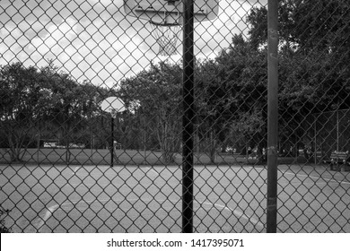 Black And White Basketball Court From Behind Fence