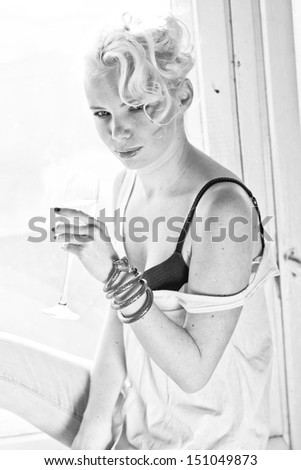 Black and white blond hair fashion model with champagne