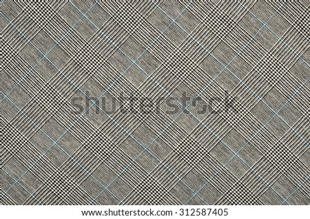 Black and white with blue houndstooth pattern in squares. Black and white wool twill pattern. Woven dogstooth check design as background.