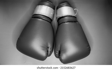 Black And White Boxing Gloves With No People And Solid Color Background.