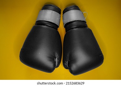 Black And White Boxing Gloves With No People And Solid Color Background.