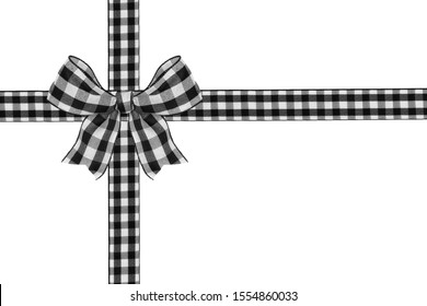 Black and white buffalo plaid Christmas gift bow and ribbon arranged as wrapped gift box isolated on a white background