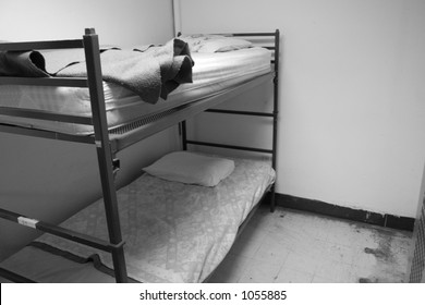 Black And White Of Bunk Beds In Homeless Shelter.