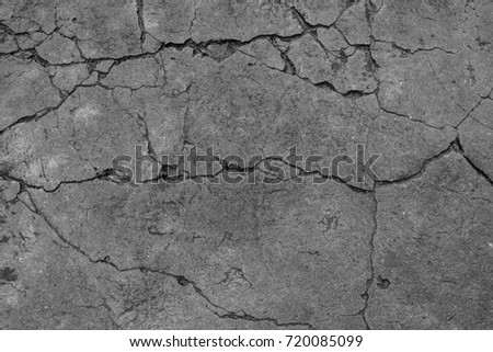 Black and white cement ground background and pattern. It is cracked of  concrete street road and very fractious. The damage is caused by the impact and vibration of the ground and long-time use