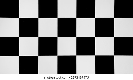 Black and white checkered surface of vintage empty chessboard close up view