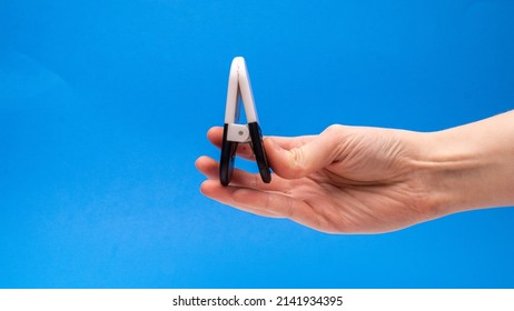 Black And White Chip Clip Closed Upwards On Blue Background