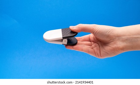 Black And White Chip Clip Closed Angled Side View On Blue Background