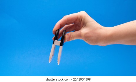 Black And White Chip Clip Opened Downwards On Blue Background