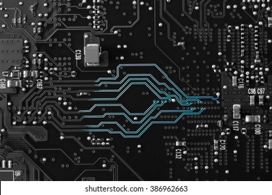 A black and white circuit board with neon blue showing on the lines to show the communication highway of the circuitry. Flat layout, copy space, use as a horizontal or vertical format.