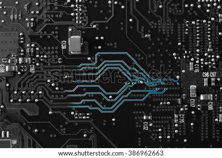 A black and white circuit board with neon blue showing on the lines to show the communication highway of the circuitry. Flat layout, copy space, use as a horizontal or vertical format.