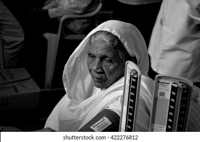 A Black And White Close Up Image Of An Old Woman Getting Her Blood Pressure Checked At A Medical Camp In Mumbai,India.Image Taken On 17/02/2011