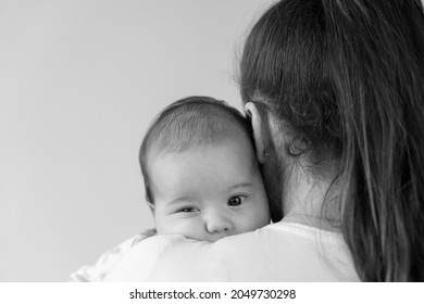 Black And White Close Up Portrait Face Of Mom With Chubby Newborn Baby Copy Space. Young Cute Caucasian Woman Holding Awake Child In Arms Motherhood, Infancy, Childhood, Family, Mother's Day Concept