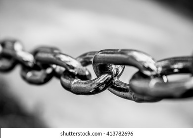 Black and white close up shot to a stretched chain. - Shutterstock ID 413782696