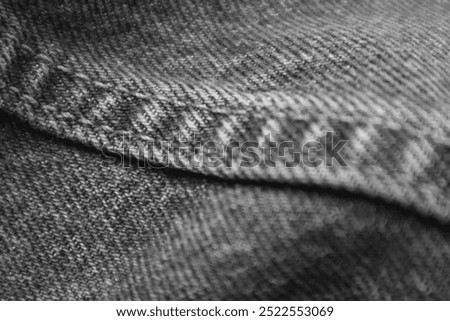 A black and white close-up image of Levi's 505 jeans, focusing on the detailed stitching and fabric texture, showcasing the ruggedness and design of the denim.