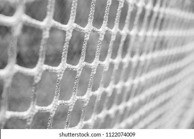 Black and white closeup image of sports netting from a lacrosse goal - Powered by Shutterstock