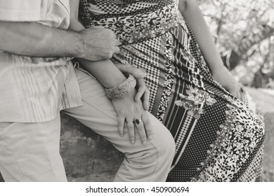Black and white closeup view on romantic couple holding hands outdoors background. Happy hugging people.