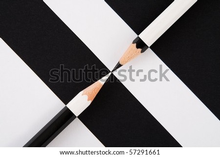 black and white composition of pencils and bands