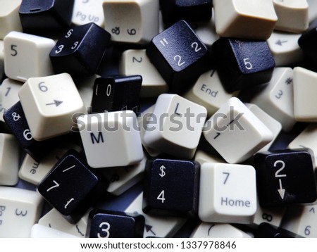 Black and white computer keyboard keys, mostly numeric with ML (Machine learning) buttons at the front. Concept of unstructured big data for data science and deep learning.