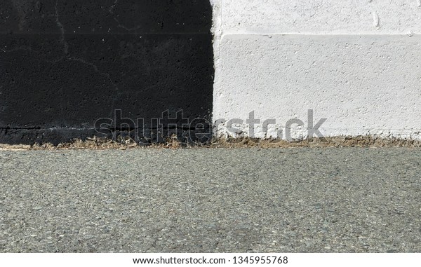 Black
and white concrete curb with asphalt road 
close-up