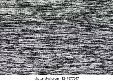 Black and white cotton fabric background.
Close up gray cotton fabric texture background.  
White textured knit. 
Selective focus.
top view. - Shutterstock ID 1247877847